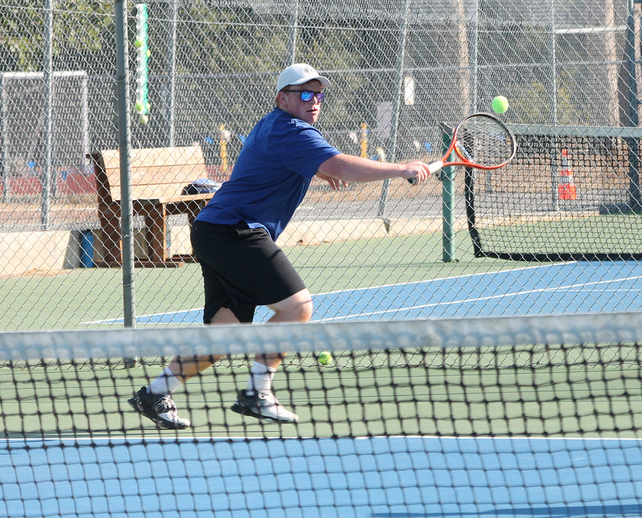 Brent de Wolf uses a backhand to return a shot in first doubles.(Photo by Jim Waller/South Whidbey Record)