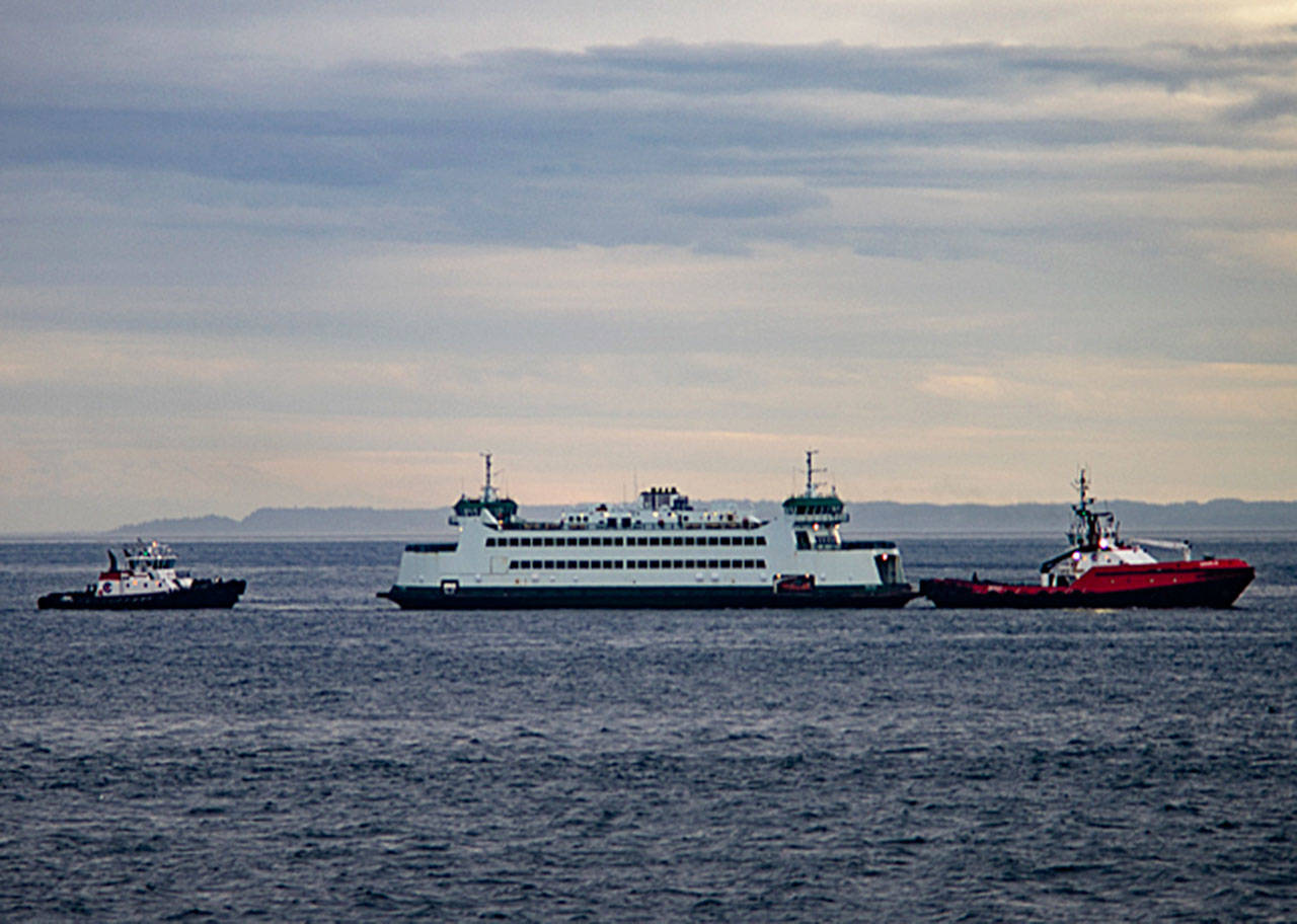 Photo by David Stern - Whidbey Custom Photography                                The Salish is towed by a tug back to Port Townsend after making a soft grounding in Keystone Harbor. The vessel’s rudder was damaged and the Coupeville-to-Port Townsend run will be down to one boat until it can be fixed.