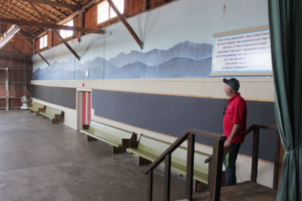 Fairgrounds director Larry Lehtonen walks through the Pole Building, the first facility built for the fair in 1937. A wedding and fundraising event recently took place there. (Photo by Patricia Guthrie/Whidbey News Group)