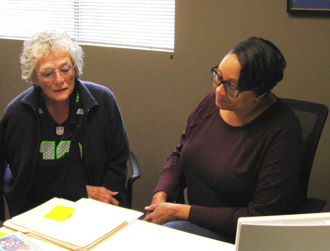 Photo by Dave Felice                                <em>Maureen MacDonald (left) of the Genealogical Society of South Whidbey Island (GSSWI) looks at documents with Island County Historical Society archivist Cassie Rittierrodt.</em><em></em>