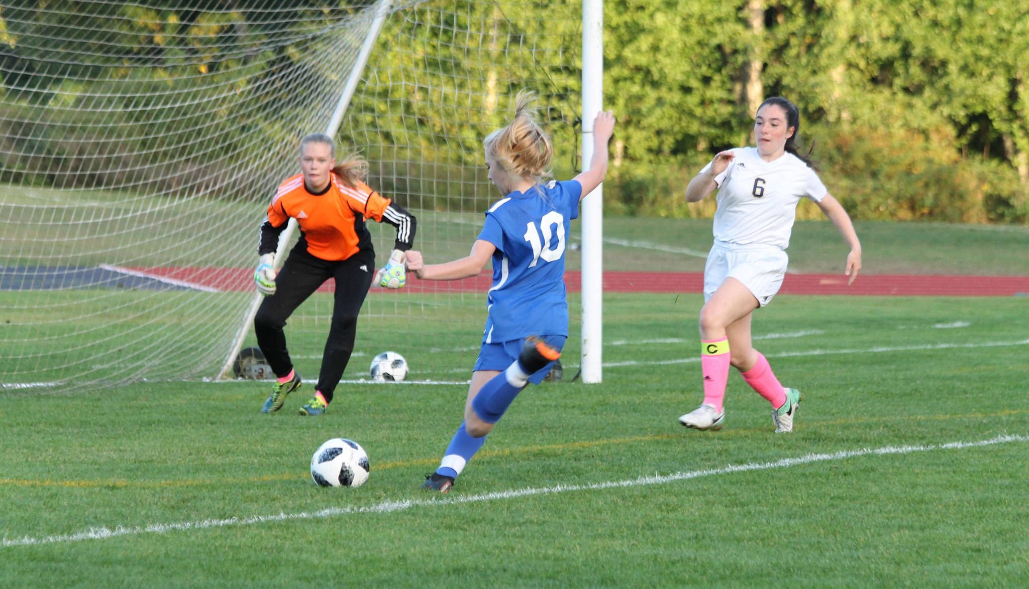 Mikenna Wicher punches in South Whidbeys first goal in a 5-0 win over Cedar Park Christian. (Photo by Jim Waller/South Whidbey Record)