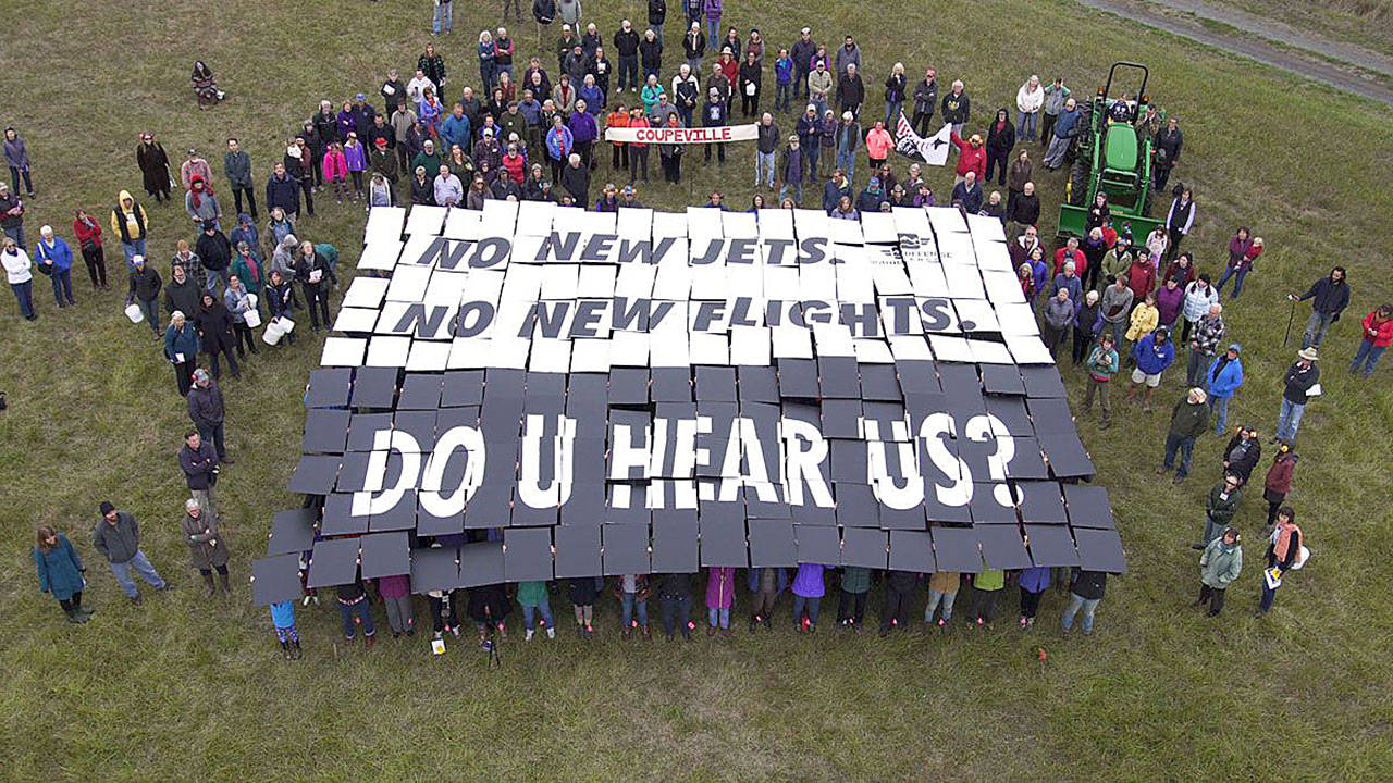 Photo courtesy of Sound Defense Alliance                                Nearly 200 people concerned about Growler jet noise participated in a “card stunt” outside the Crockett Barn Wednesday.