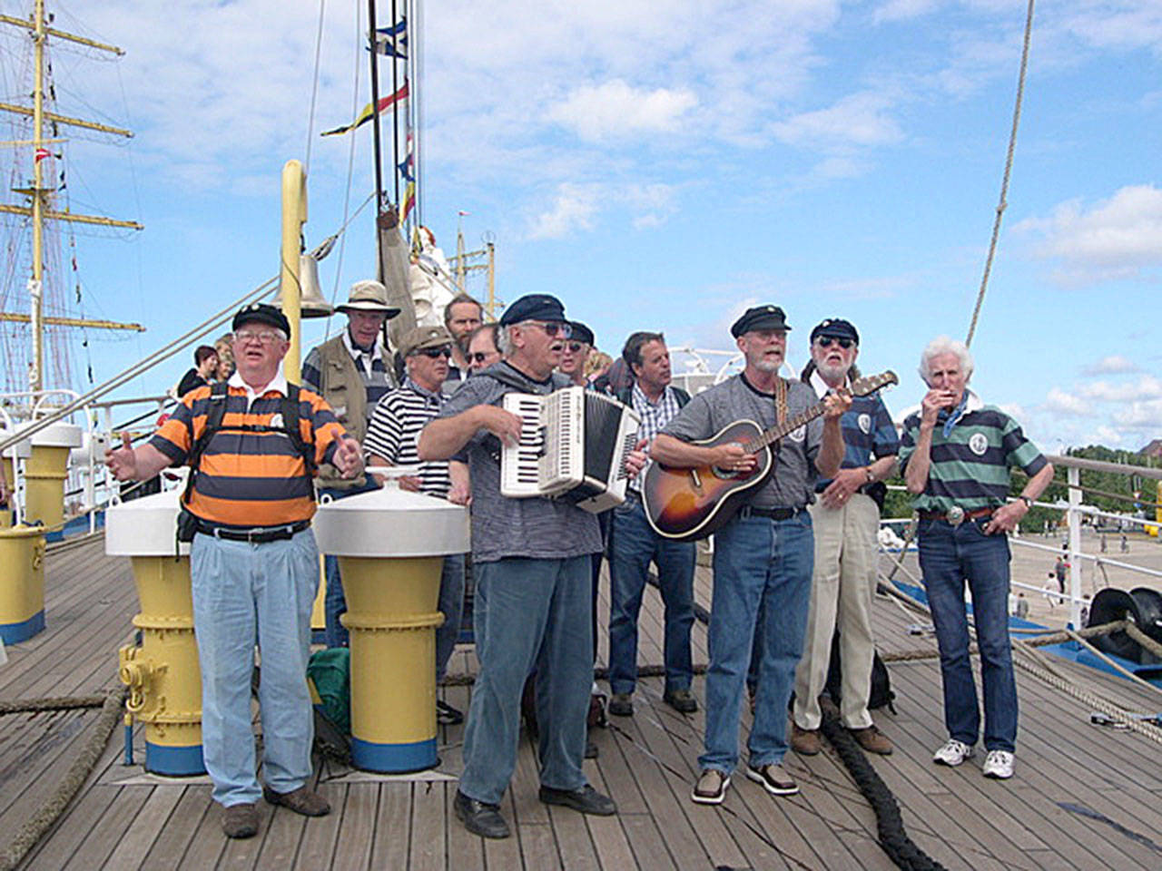 Photo provided                                The Shifty Sailors play at the Tall Ship Festival in Riga, Latvia in 2003 aboard the German sailing vessel Seute Deern. Pictured are Jim Amis, Mike Thelen, Wylie Vracin, Karl Olsen, Clarke Harvey, Vern Olsen (accordion), Ray Loe, Bruce Bardwell, Denny Armstrong (guitar), Jack Moeller and Peter Lawl.