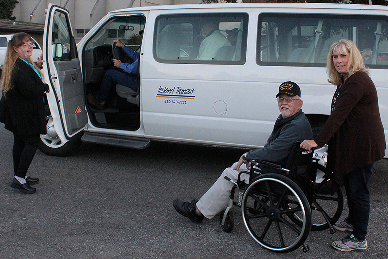 Photo by Patricia Guthrie/Whidbey News Group                                Clay Canfield helps Terri Marie Desrosiers into the Island Transit RideLink van that transports veterans to medical appointments.