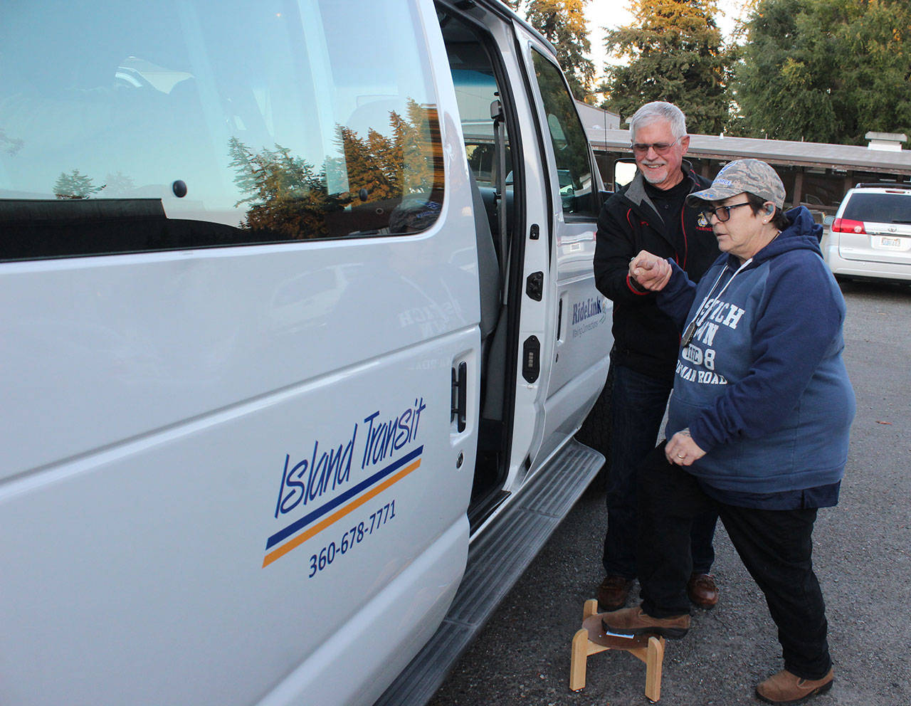 Photo by Patricia Guthrie/Whidbey News Group                                Clay Canfield helps Terri Marie Desrosiers into the Island Transit RideLink van that transports veterans to medical appointments.