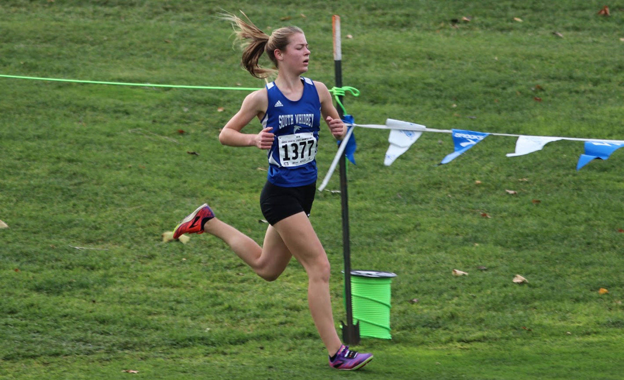 Kaia Swegler Richmond, shown here competing in the state meet, was named to the All-North Sound Conference first team in cross country. (Photo by Matt Simms)