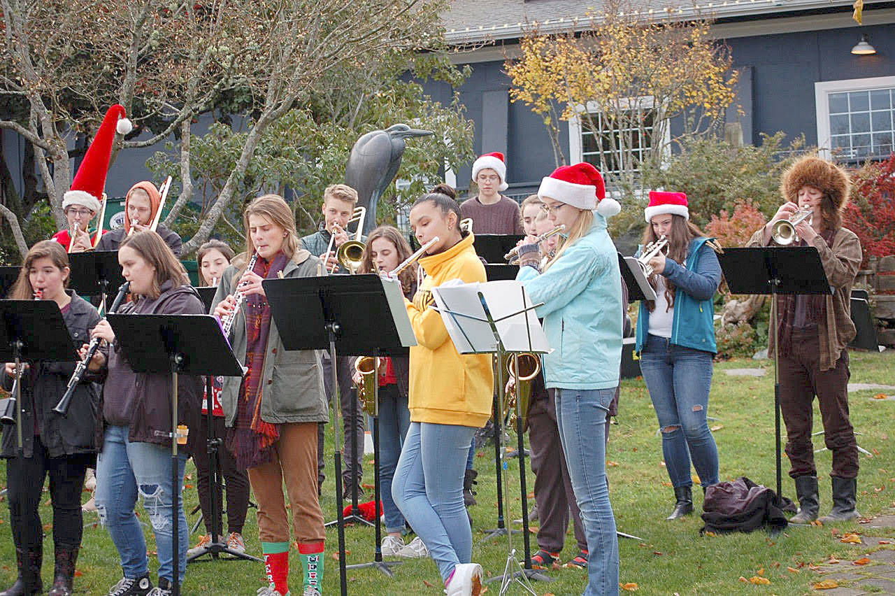 Joan Soltys photo                                Led by Chris Harshman, members of the South Whidbey High School band entertain the crowd with holiday music during the Lighting of Langley event Saturday at the city’s community park.