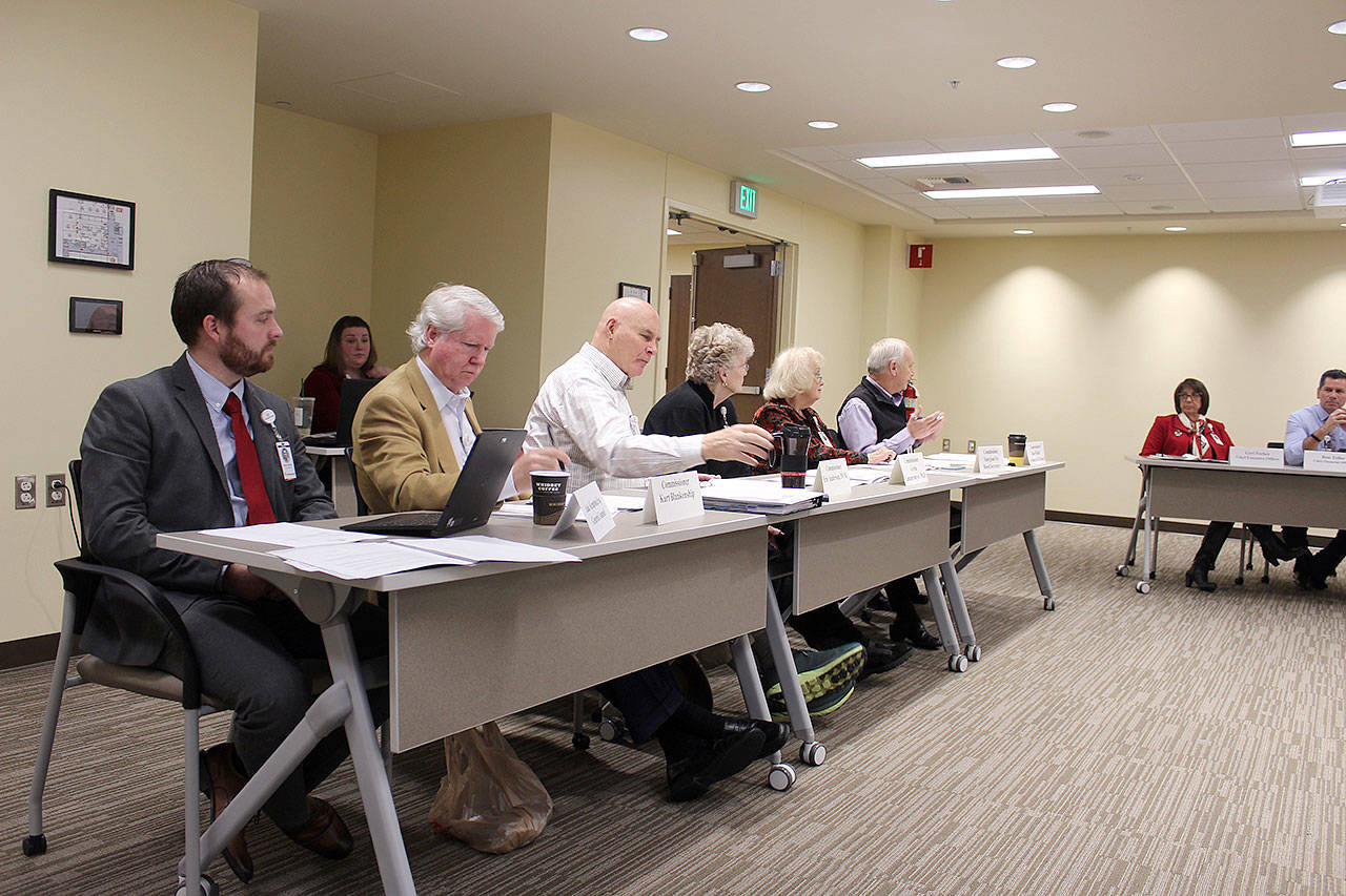 WhidbeyHealth board of commissioners, seated in the new Robert and June Sebo Health Education Center, look over next year’s budget. (Photo by Patricia Guthrie/Whidbey News Group)