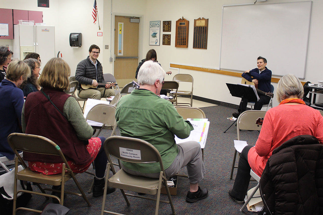 Quinn Fitzpatrick leads a weekly ukulele session with a variety of educators. Friday, they are slated to perform holiday songs in an assembly at South Whidbey Elementary School. (Photo by Patricia Guthrie/Whidbey News Group)