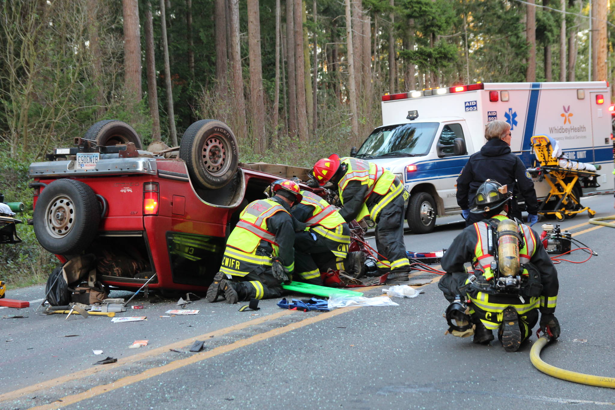 Firefighters work to extract the driver of a vehicle involved in a head-on crash.