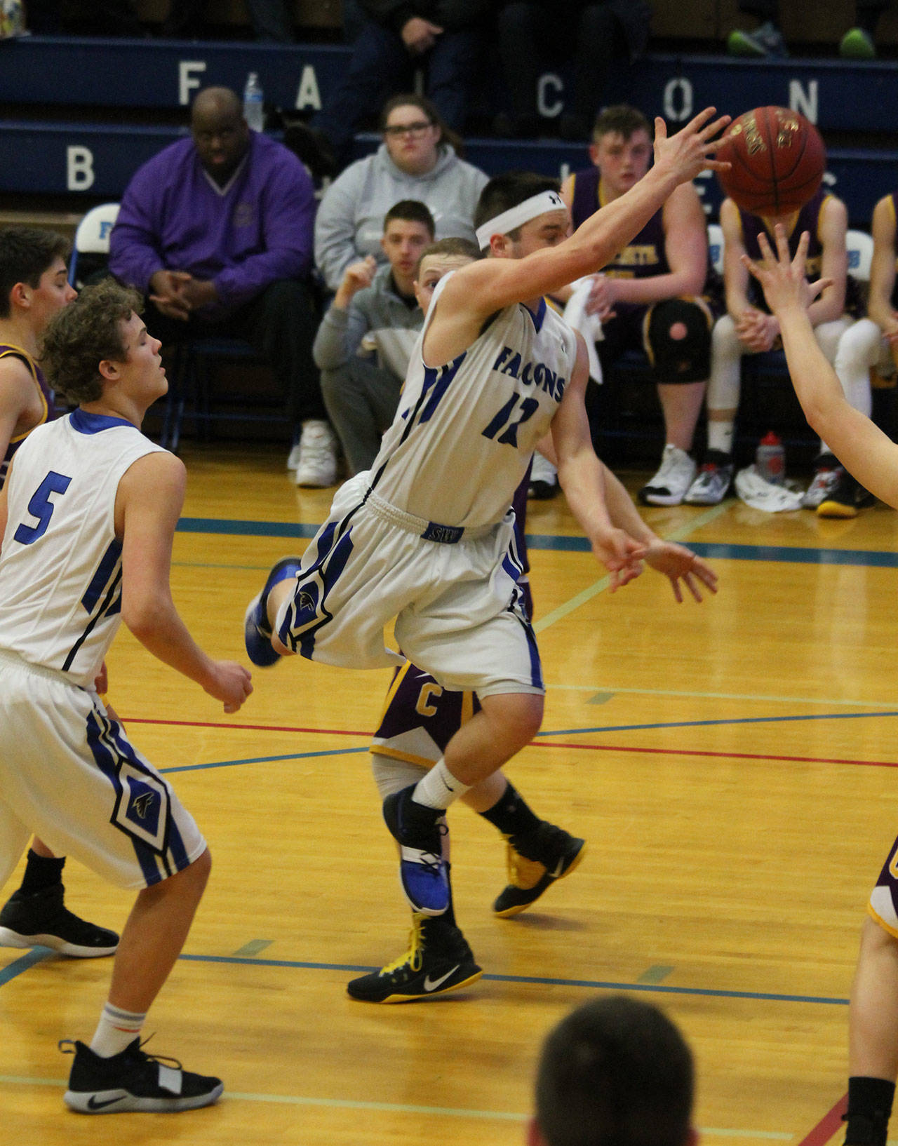 Dexter Jokinen dishes off after attacking the lane in South Whidbeys big win over Concrete.(Photo by Jim Waller/South Whidbey Record)