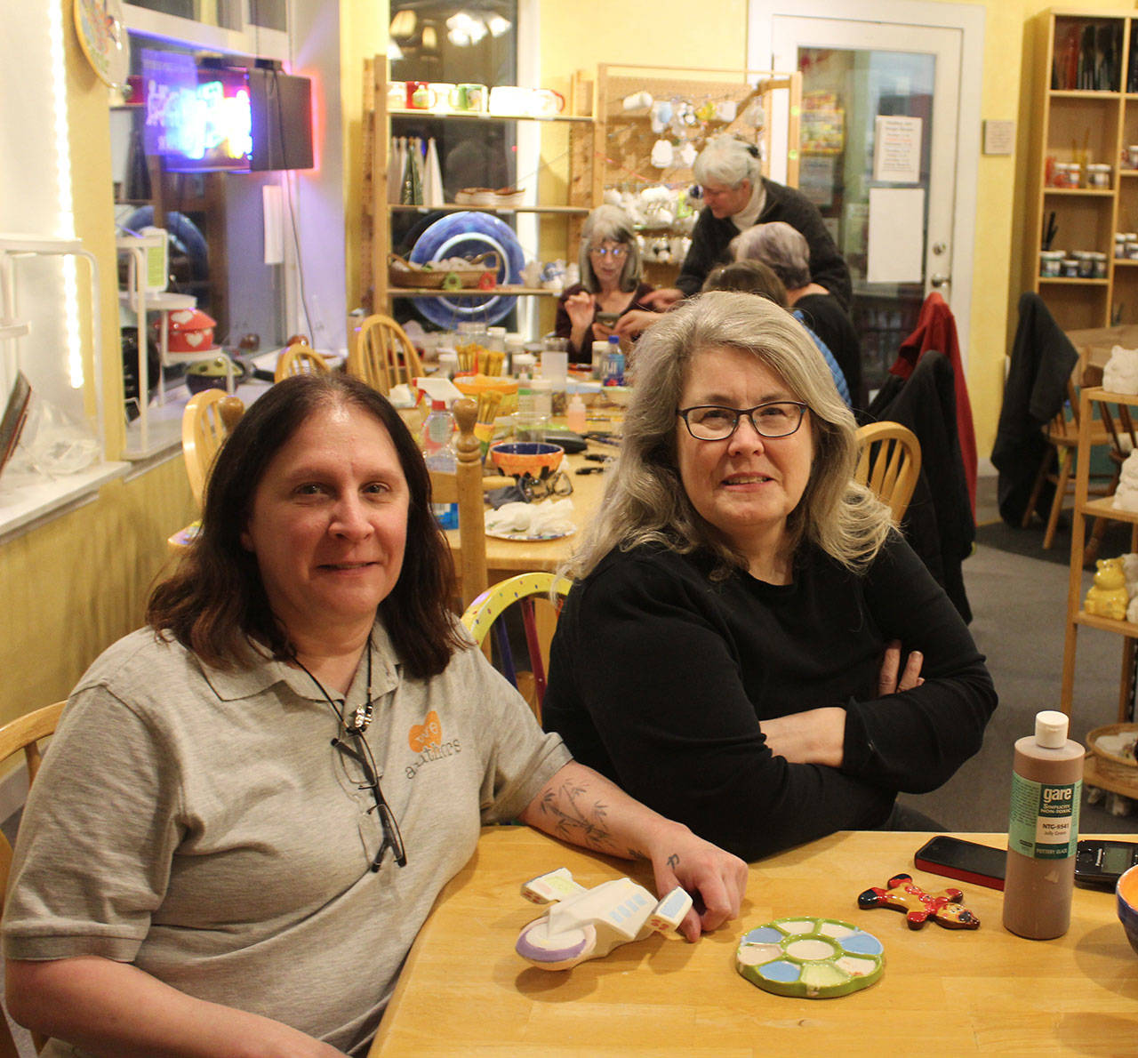Longtime Whidbey Art Escape owner Tina Beard, right, chats with new owner Carol Evans during a recent Ladies Night session. (Photo by Patricia Guthrie/Whidbey News Group)