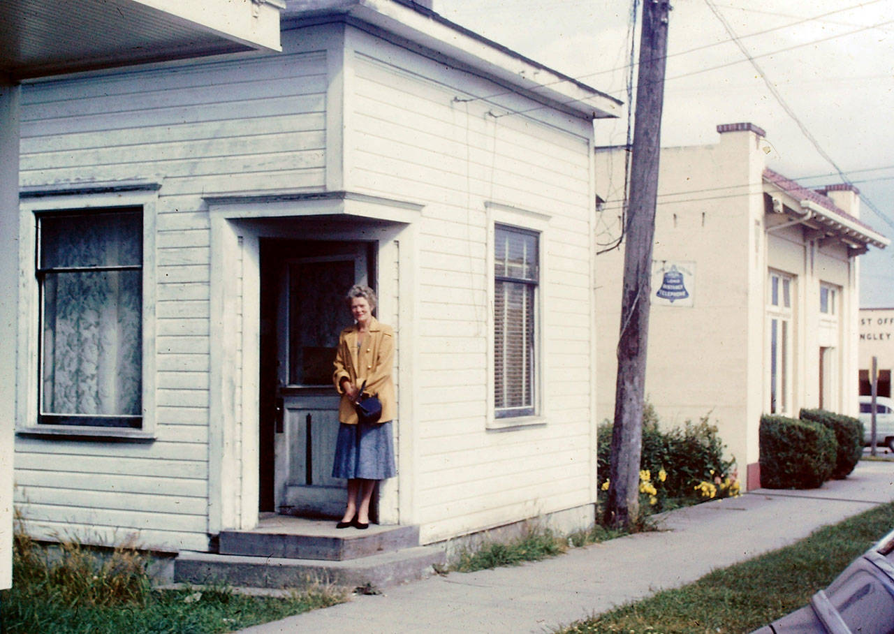 George Henny’s grandmother, Elizabeth Henny, stands in front of the original Whidbey Telephone Company building in 1957. (Photo courtesy of Henny family)