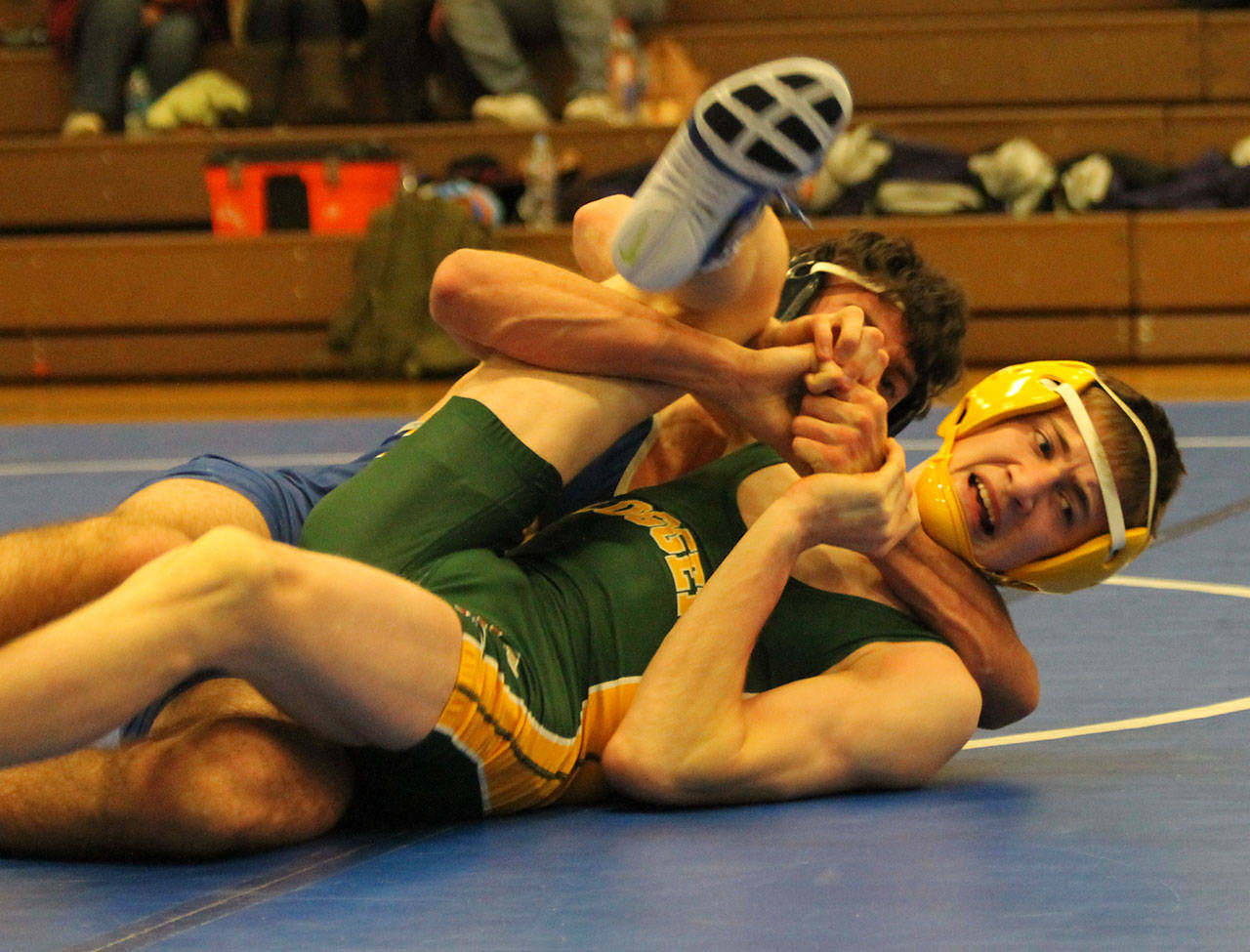 South Whidbey’s Drew Aposhyan, back, has his Darrington opponent in trouble. (Photo by Jim Waller/South Whidbey Record)