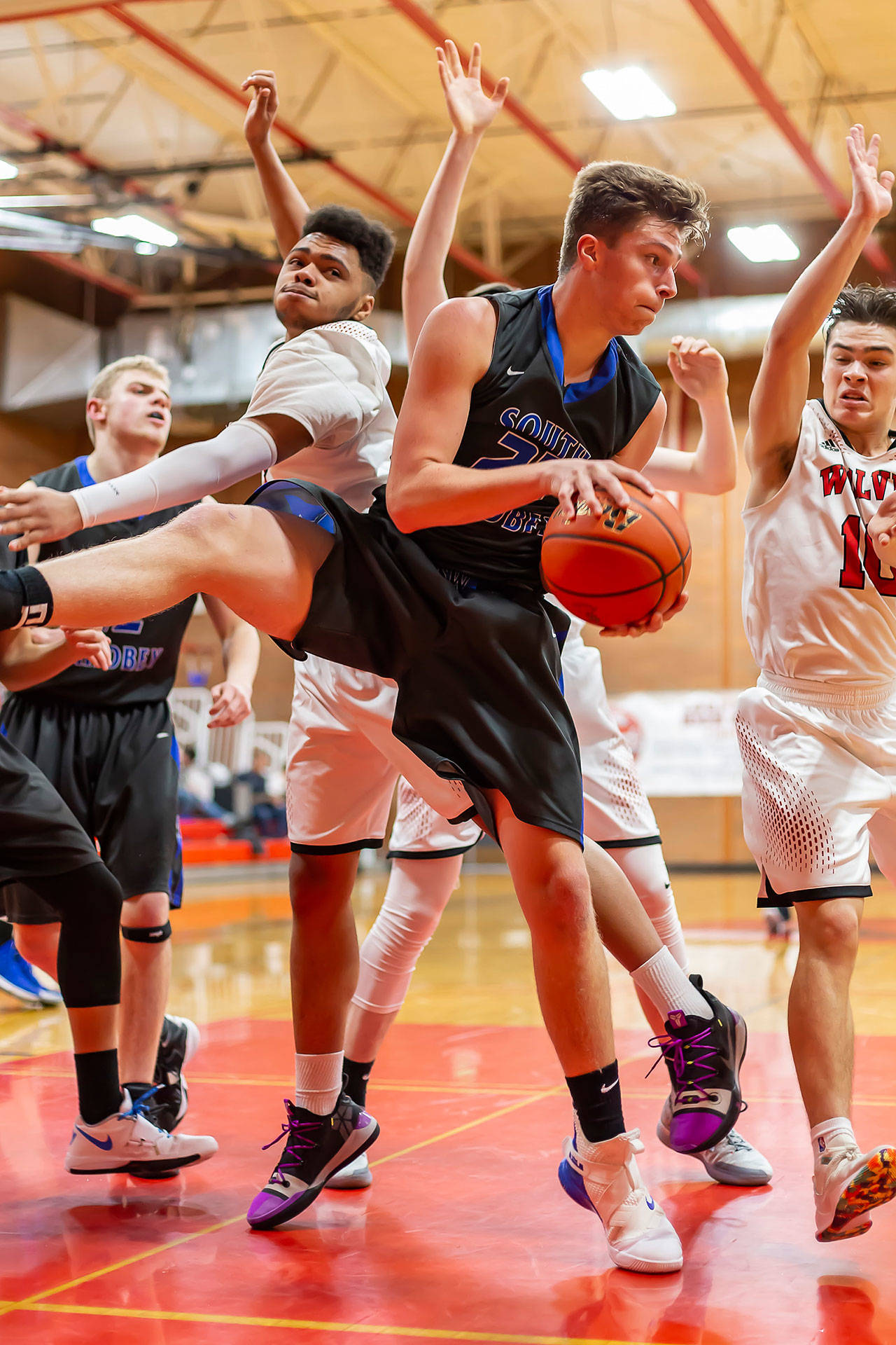 Kole Nelson hauls in one of his 10 rebounds against Coupeville Friday.(Photo by John Fisken)