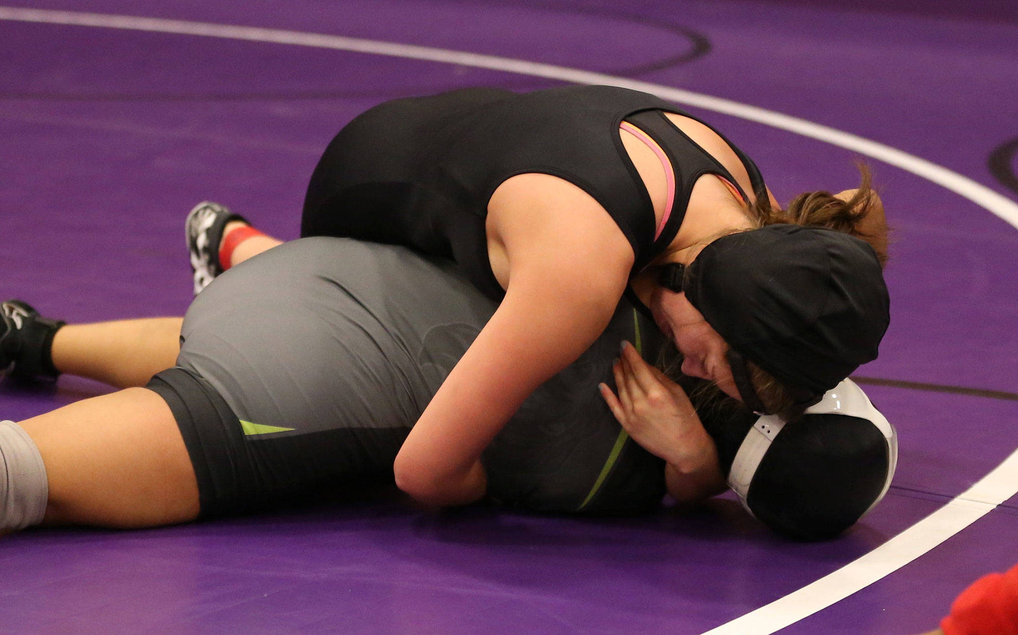 South Whidbey’s Nicole Helseth, top, tries to pin Lynden’s Jennifer Lopez.(Photo by John Fisken)