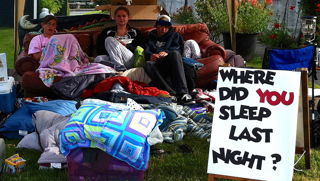 Ryan’s House for Youth has taken its beloved “big red” couch various places, including sleeping in front of Langley City Hall to raise awareness.Pictured is the couch and youth during the Chochokum arts festival in July 2011. Photo provided.