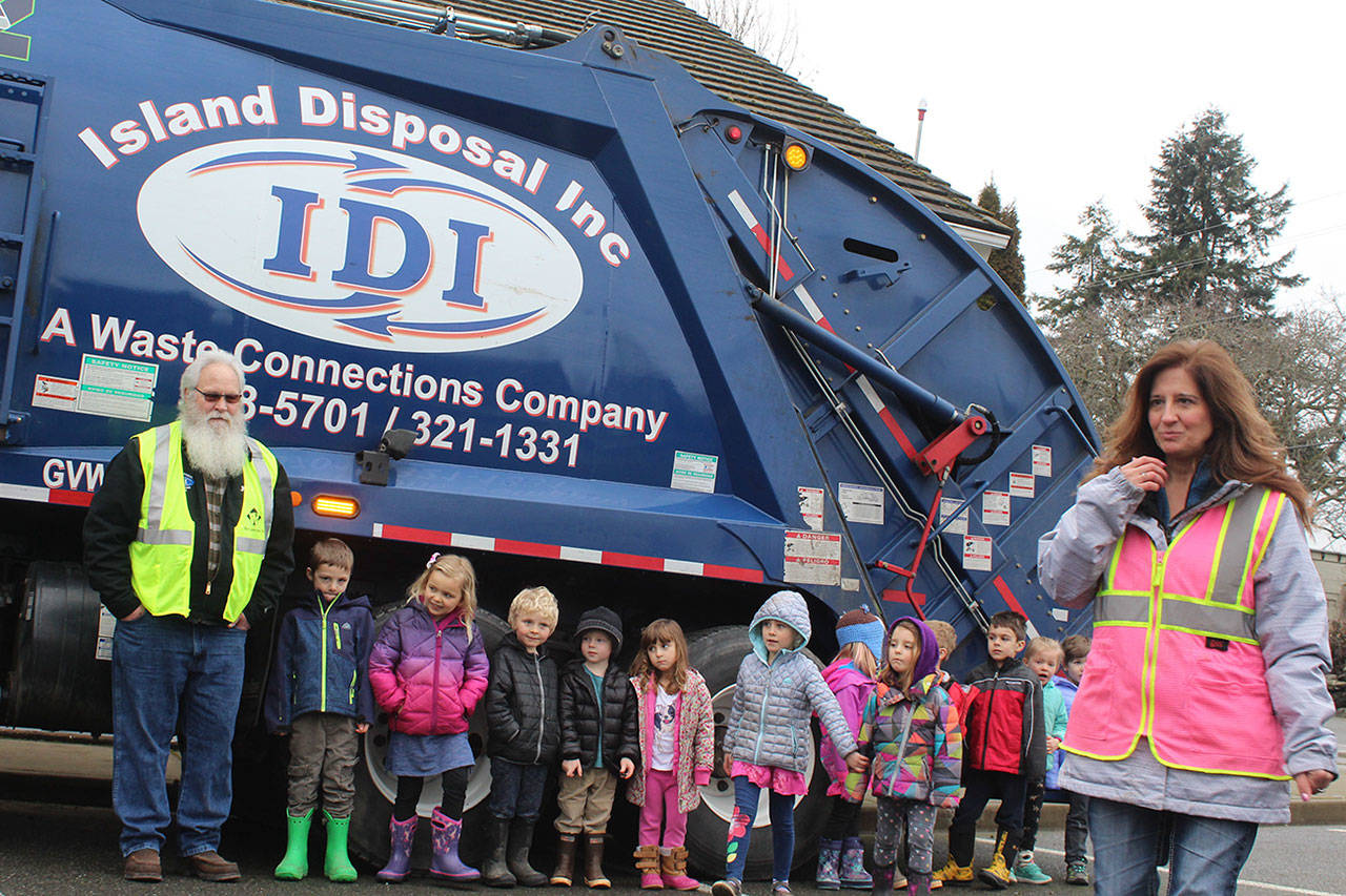 Island Disposal brings one of its garbage trucks to South Whidbey Children’s Center to give little kids a big thrill. Observed parent Caitlin Voss, “They’re obsessed with garbage trucks and recycling trucks.” (Photo by Patricia Guthrie/Whidbey News Group)