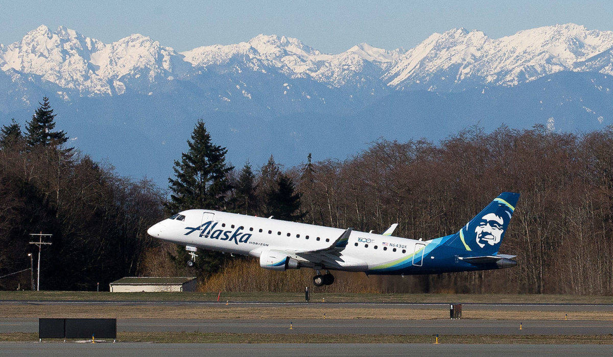 With the Olympic Mountains in the background, Alaska Airlines Flight 2878 departs for Portand on opening day of the Paine Field new passenger terminal. (Photo by Andy Bronson/The Everett Daily Herald)