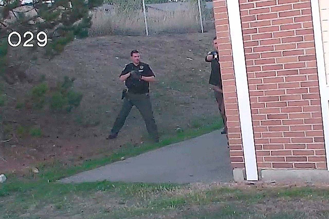 (Police photo)                                A still image from an officer’s dashcam video shows the moments before Richard Jackson is shot bypolice. Deputy Shawn Engert is at the left and Officer Patrick Horn can be partially seen at the right.