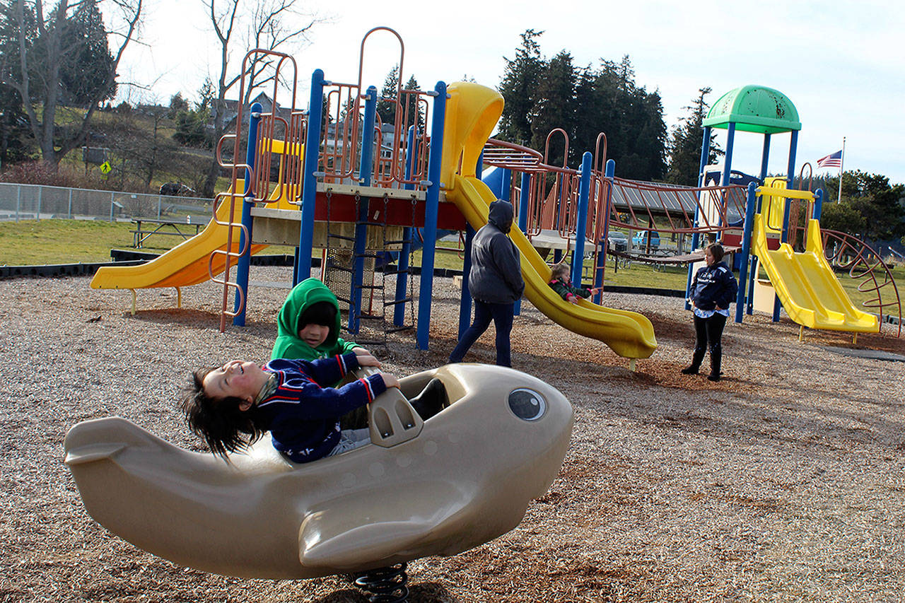 Ren Gonzalez, almost 4, expresses the joy of piloting a whale plane in the sunshine Sunday as his older brother Michi looks on. The family from Clinton took in the warm weather at Freeland Park. (Photo by Patricia Guthrie/Whidbey News Group)