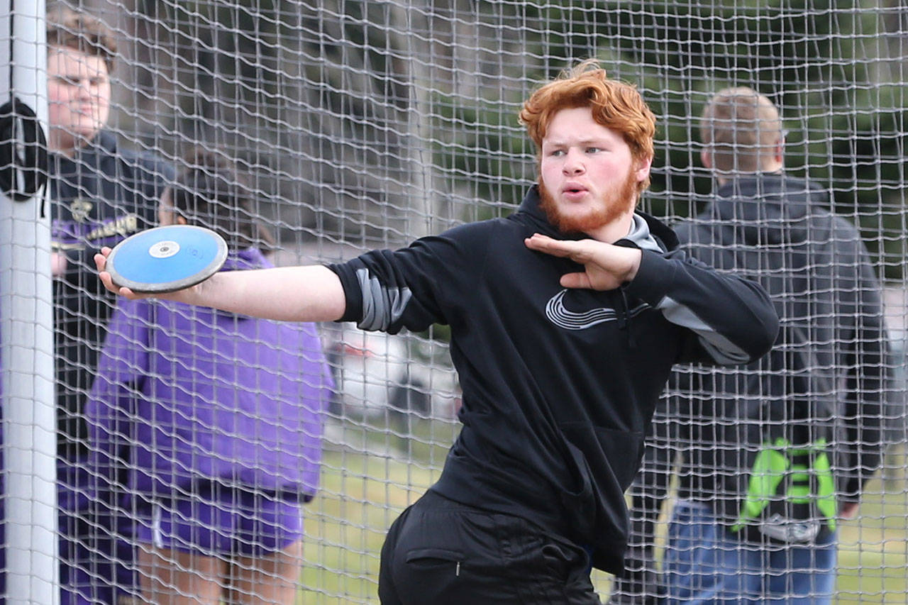 Casey Justus gets ready to throw the discus at the Island Jamboree in Oak Harbor Thursday. (Photo by John Fisken)