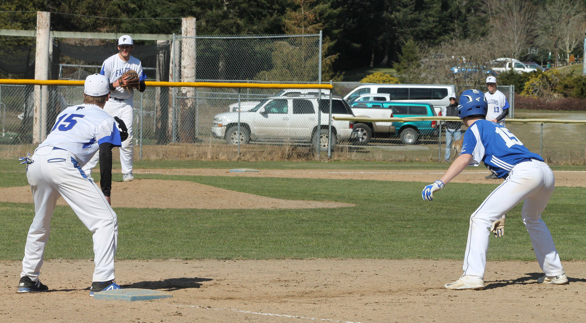 Pitcher Brent Batchelor and first baseman Nick Young hold the Chimacum baserunner close.(Photo by Jim Waller/Sound Whidbey Record)