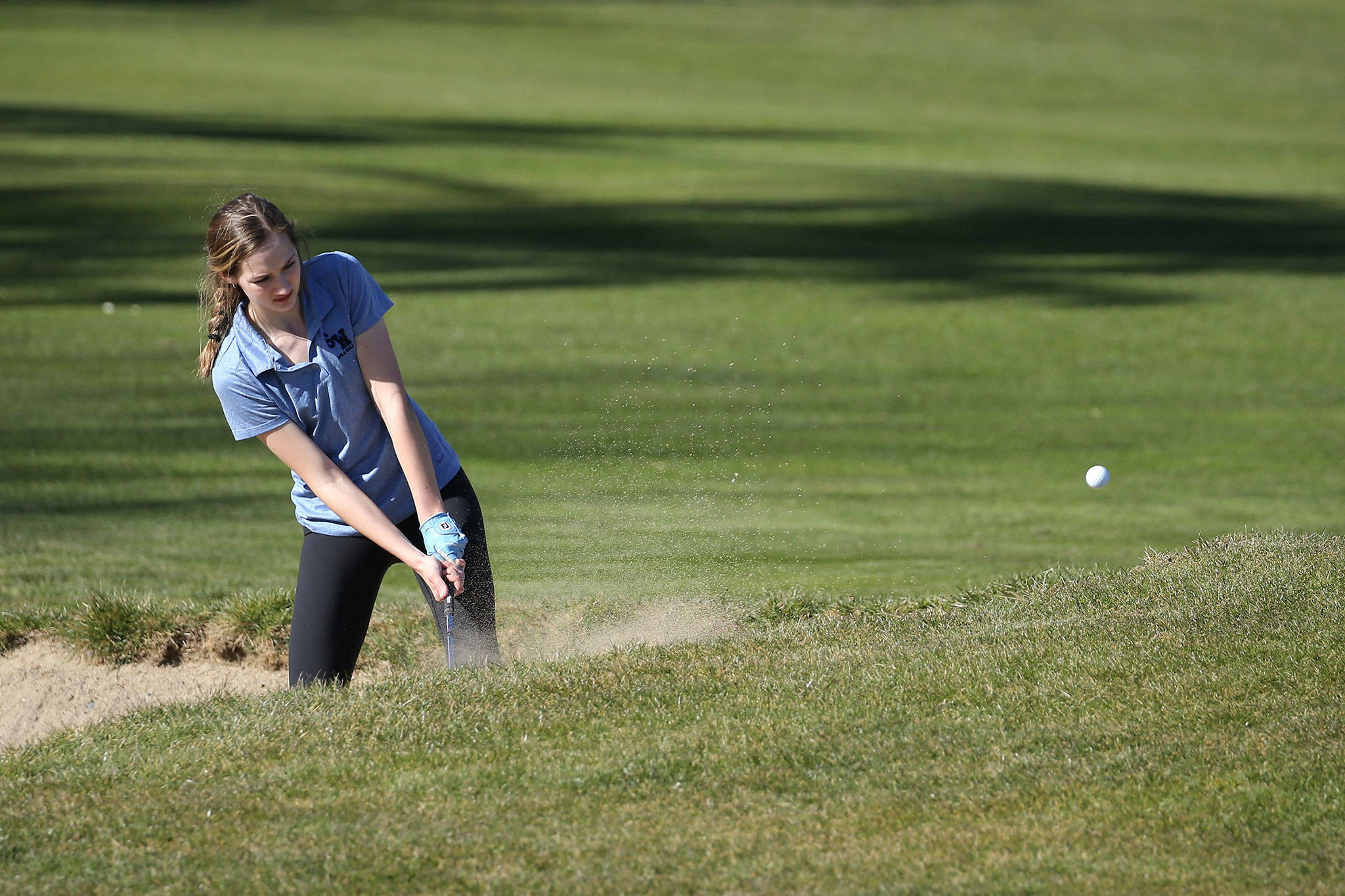South Whidbey’s Alyssa Ludtke blasts out of trouble at the Whidbey Shootout Tuesday. (Photo by John Fisken)