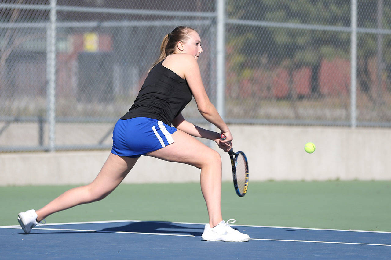South Whidbey’s Mary Zisette runs down a shot in her first doubles win with partner Alison Paprtiz.(Photo by John Fisken)