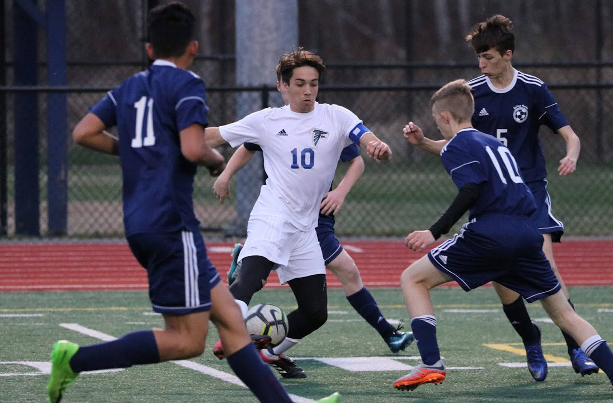South Whidbeys Michael Lux (10) draws a crowd at Sultan Wednesday. Lux scored four goals in the Falcons 7-1 win.(Photo by Matt Simms)