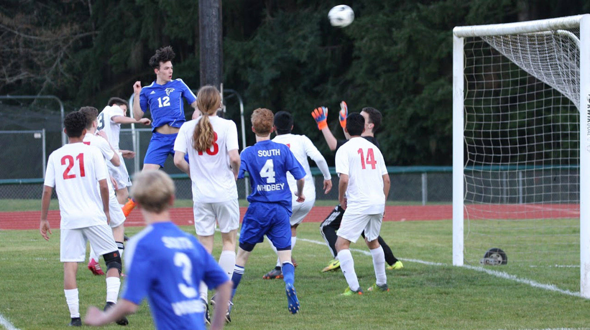 South Whidbey’s Nevin Daniels (12) drives a header toward the goal in Friday’s match with Coupeville. (Photo by Matt Simms)