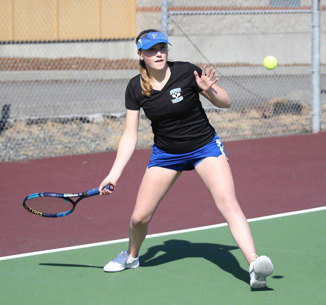 South Whidbey’s Mary Zisette prepares to send a shot back Coupeville’s way in first doubles.(Photo by John Fisken)