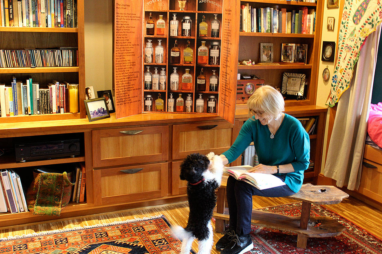 Poet Judith Adams at her home in Langley with her puppy, Jack. Chosen for the second time to be a Washington Humanities speaker, Adams has many events planned this month around the state during National Poetry Month. (Photo by Patricia Guthrie/Whidbey News Group)