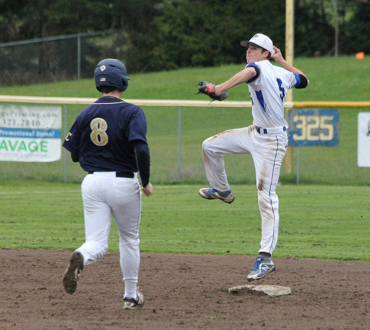 Falcon second baseman Jon Bartel jumps to throw to first in an attempt to turn a double play.(Photo by Jim Waller/South Whidbey Record)