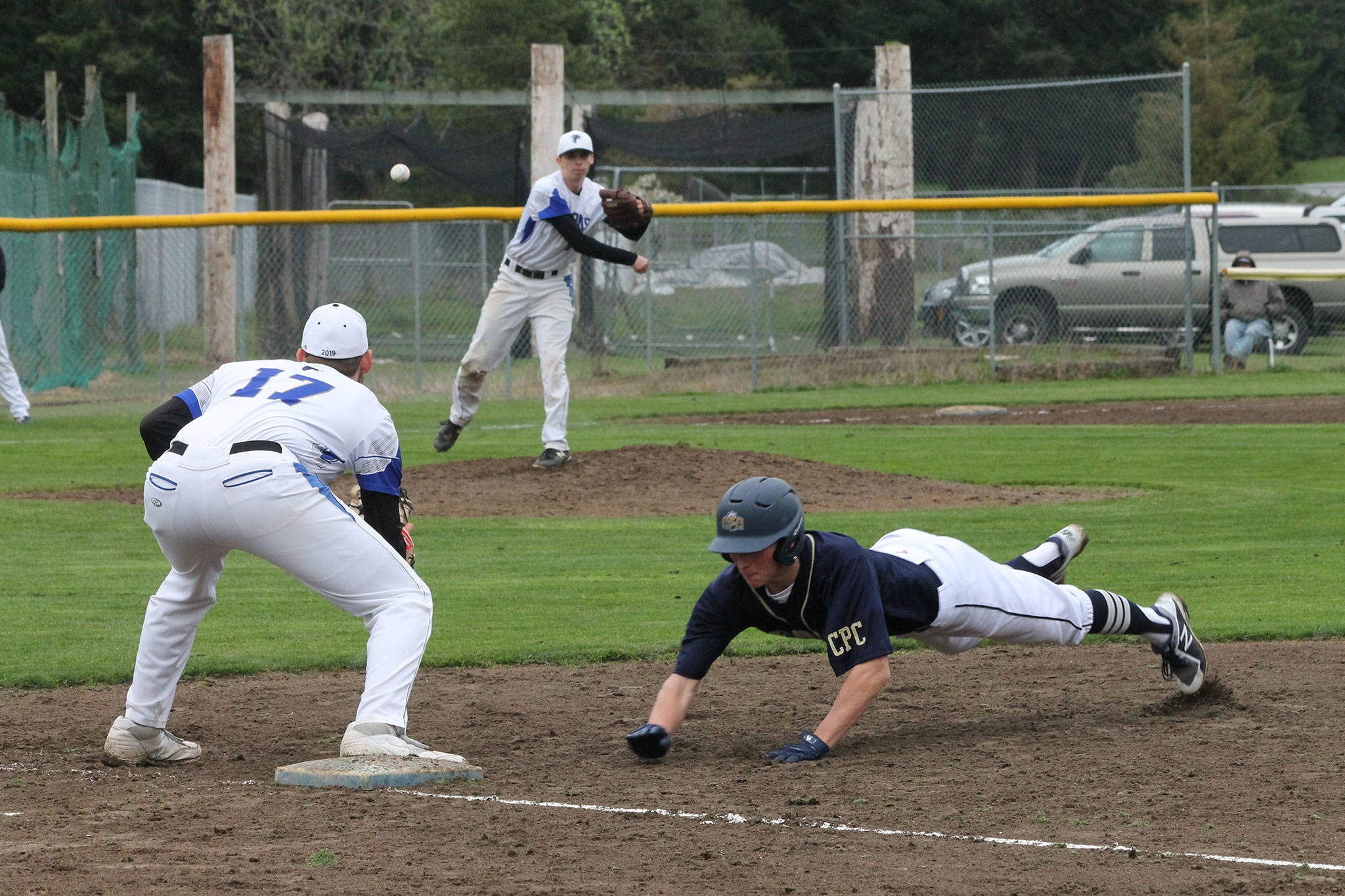 South Whidbey pitcher Ethan Petty throws to first baseman Brent Batchelor in an attempt to pick off a Cedar Park Christian runner.(Photo by Jim Waller/South Whidbey Record)