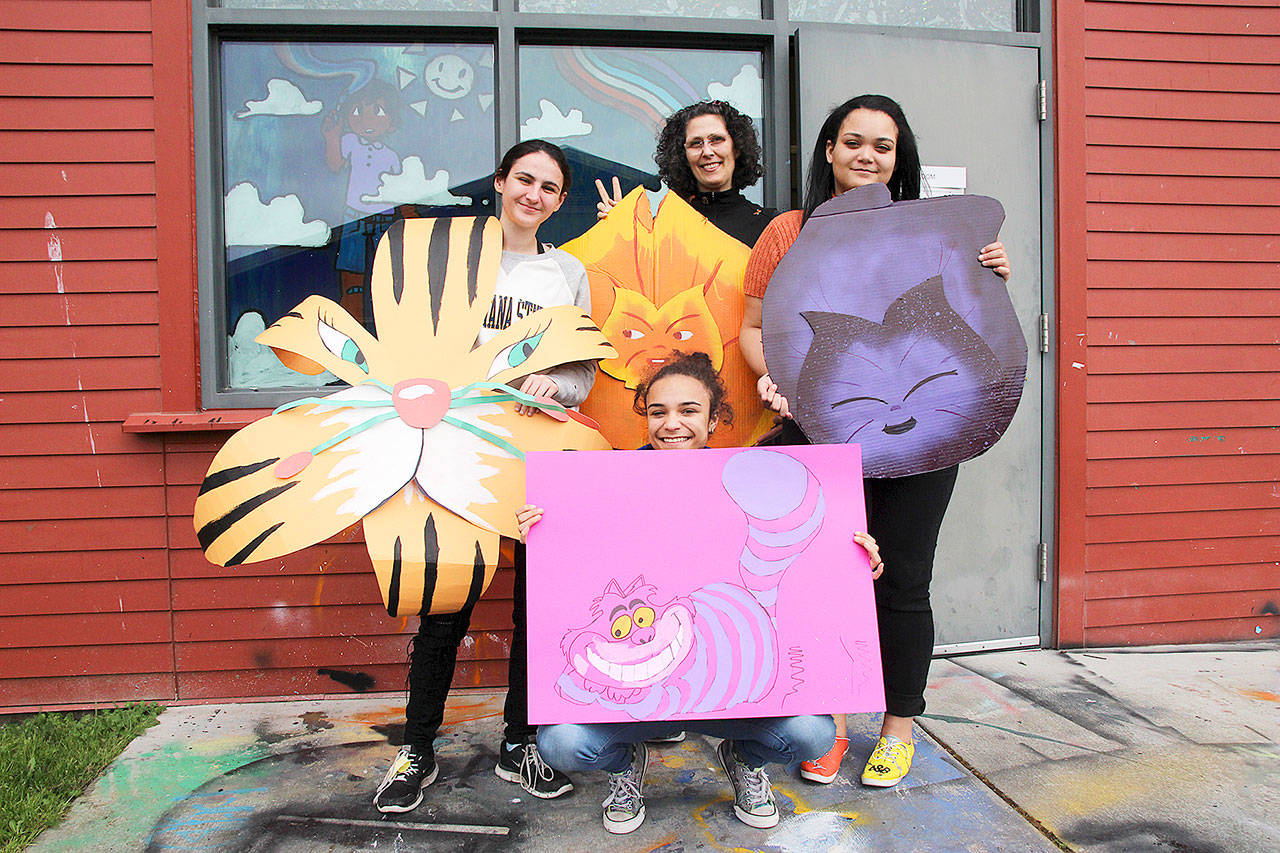 From left, student Pride and Allies Club members Madison Rixe, Tamika Nastali and Kalasya Hart and advisor Tacy Bigelow show off Alice in Wonderland-themed decorations for this year’s Rainbow Prom. (Photo by Laura Guido/Whidbey News Group)