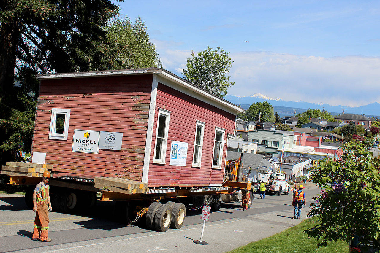 The house-moving company, Nickel Bros, successfully finessed the 30,000-pound wooden structure into its new location Tuesday, rolling it slowly down Second Street. (Photo by Patricia Guthrie/Whidbey News Group)