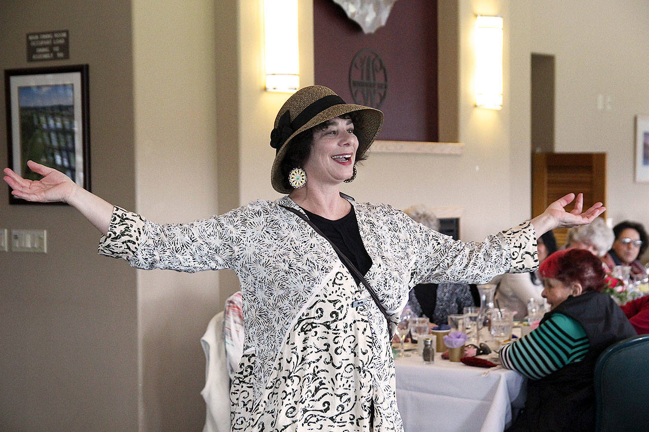 Patricia Duff, a spokeswoman for WhidbeyHealth, shows off a selection of items available at the hospital gift shop. The Polly Harpole Hospital Guild held its annual fashion show fundraiser Thursday at Whidbey Golf Club. Photo by Laura Guido/Whidbey News-Times