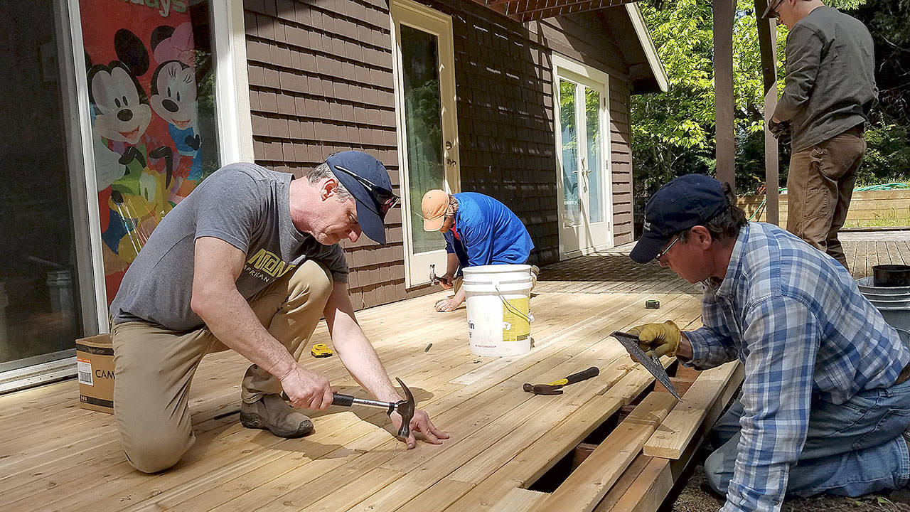 South Whidbey Hearts & Hammers volunteers, including house captain Ken Murray, center, work on a project Saturday. (Photo provided)