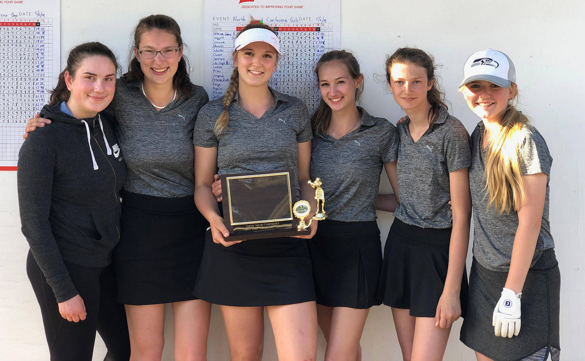 The South Whidbey girls golf team — Olivia Varga, left, Tori Schuller, Emma Leggett, Alyssa Ludtke, Bella Pierce and Caitlin Sullivan — show off their North Sound Conference championship trophy. (Submitted photo)