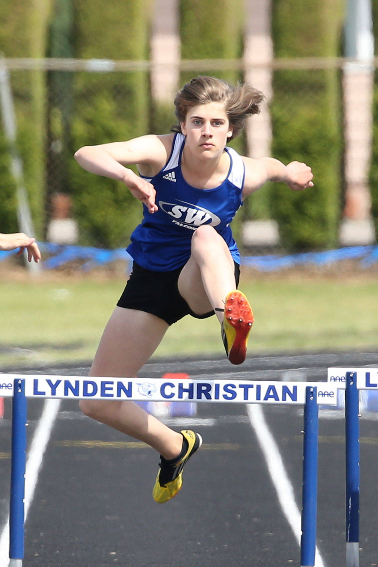 Molly Cobbs runs to fourth place in the 300 hurdles. (Photo by John Fisken)