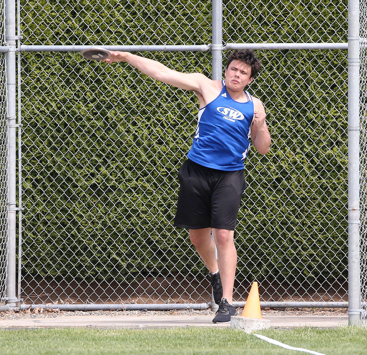 Dylan Davis tosses the discus at the district meet.(Photo by John Fisken)