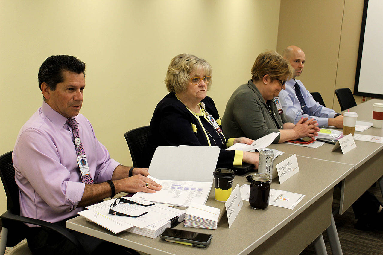 Ron Telles, left, received a one-year contract as the new CEO of WhidbeyHealth at a Monday board meeting. (Photo by Patricia Guthrie/Whidbey News Group)