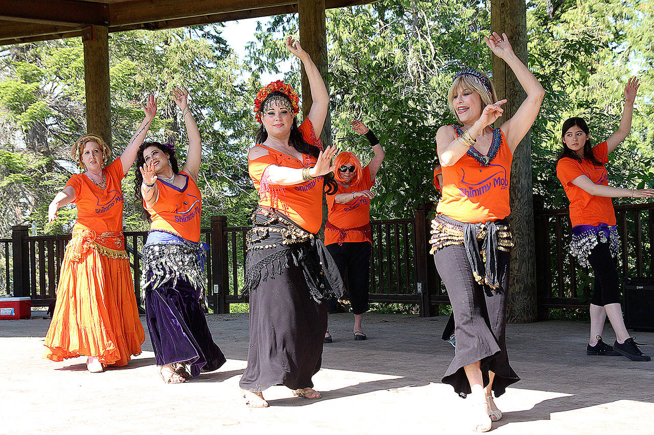 Photo by Laura Guido/Whidbey News-Times                                From left, Shimmy Mob belly dancers Holly Orange, Chandani Teresa Ortego, Tessa May and Badeah Shirazi peform Saturday at Coupeville Town Park. The annual flash mob is held at locations worldwide to promote awareness of abuse.