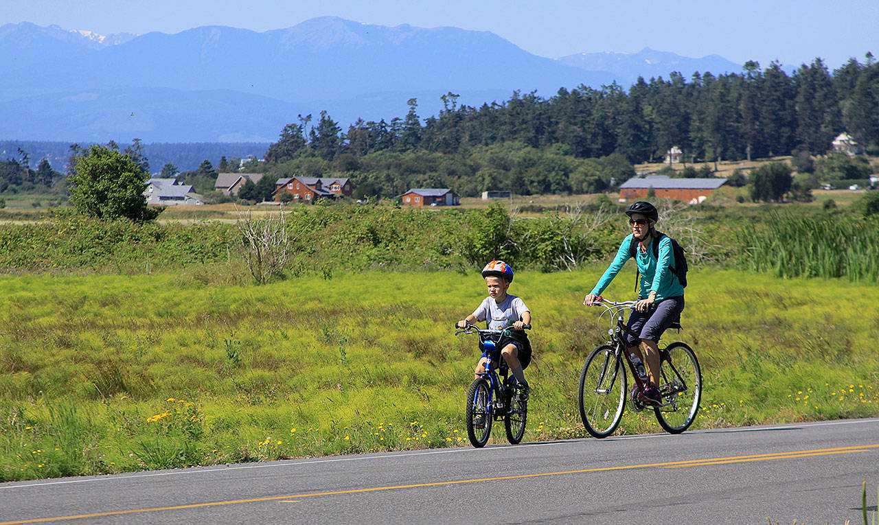Photos provided.                                Riders pedal next to farmland near Crockett Lake during the Whidbey Camano Land Trust’s 2018 Sea, Trees, Pie Bike Ride.