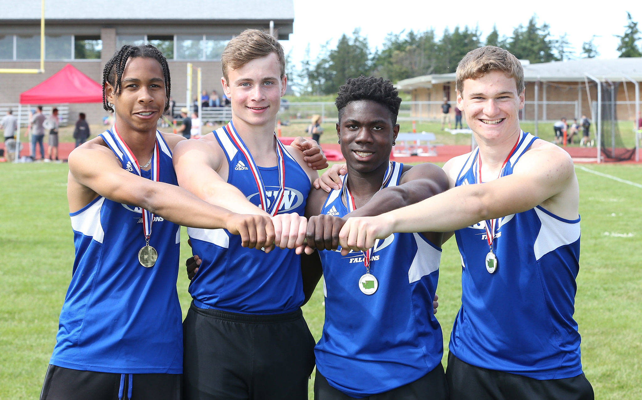 South Whidbey’s boys 4x100 relay team of Issiah Gonzales, left, Bodie Hezel, Carl Henri Chapman and Caden Spear finished first at bi-district and earned a state berth. (Photo by John Fisken)