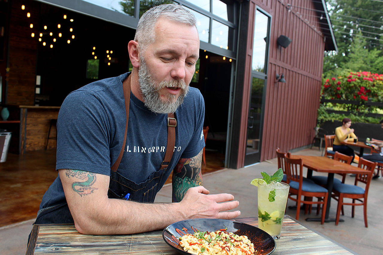 Owner J.P. Dowdell serves up a bowl of his favorite mac-n-cheese dish and a Gingered Mint Mojito on the outside patio of Porters Public House, formerly the gastropub of Roaming Radish. (Photo by Patricia Guthrie/Whidbey News Group)