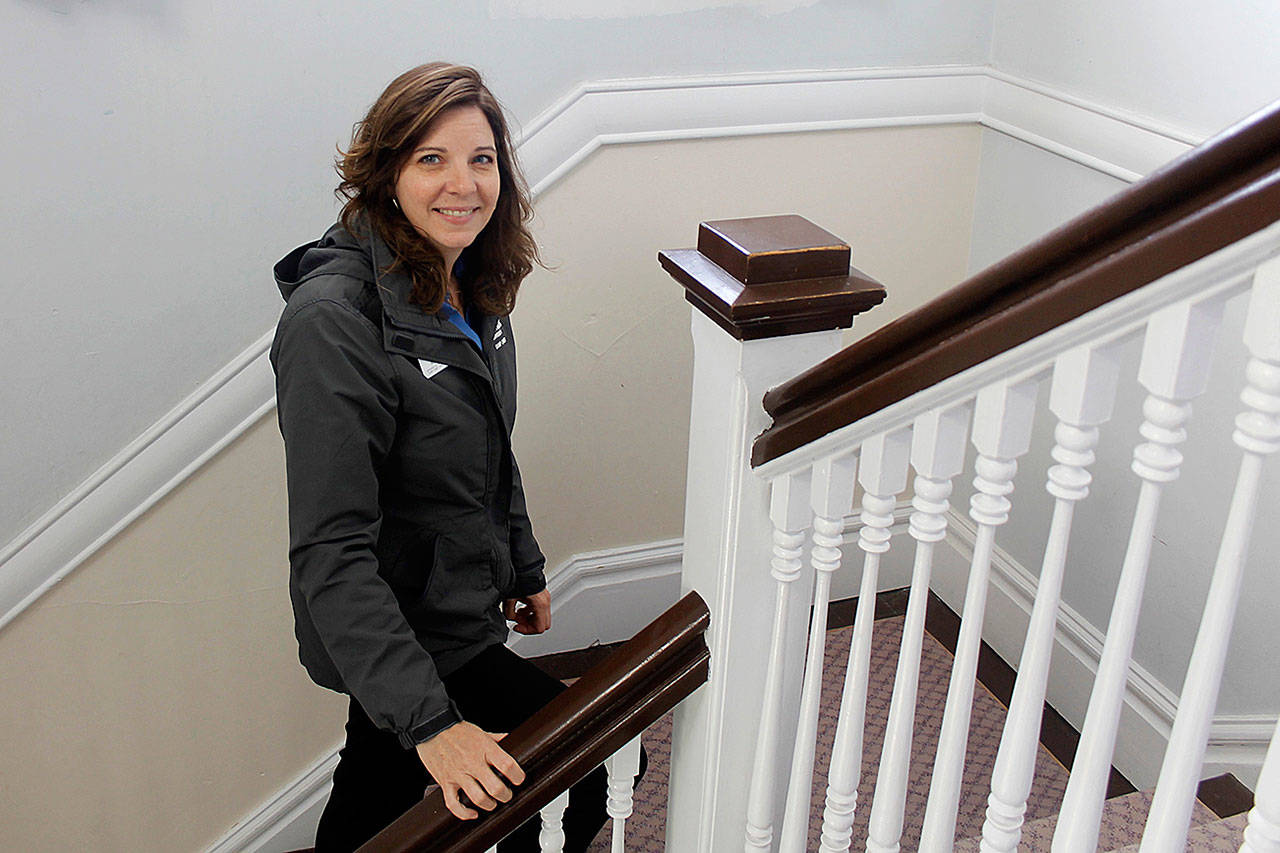 (Photo by Maria Matson/Whidbey News Group)                                Robyn Myers ascends the stairs in the Colonel’s House, a popular destination for visitors at the annual open house at Camp Casey.