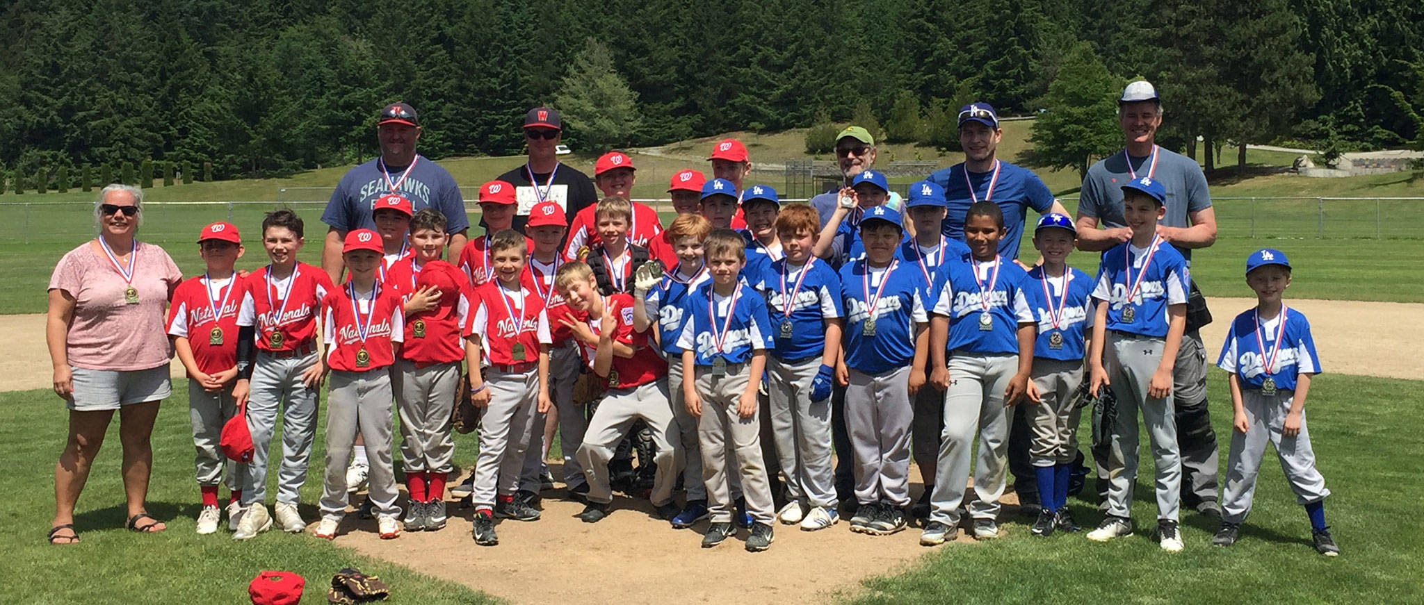 The South Whidbey Little League Nationals, left, and Dodgers show off their medals after competing in the championship game of the Henry Pope Tournament. The Nationals defeated the Dodgers 3-1 for the title. (Submitted photo)