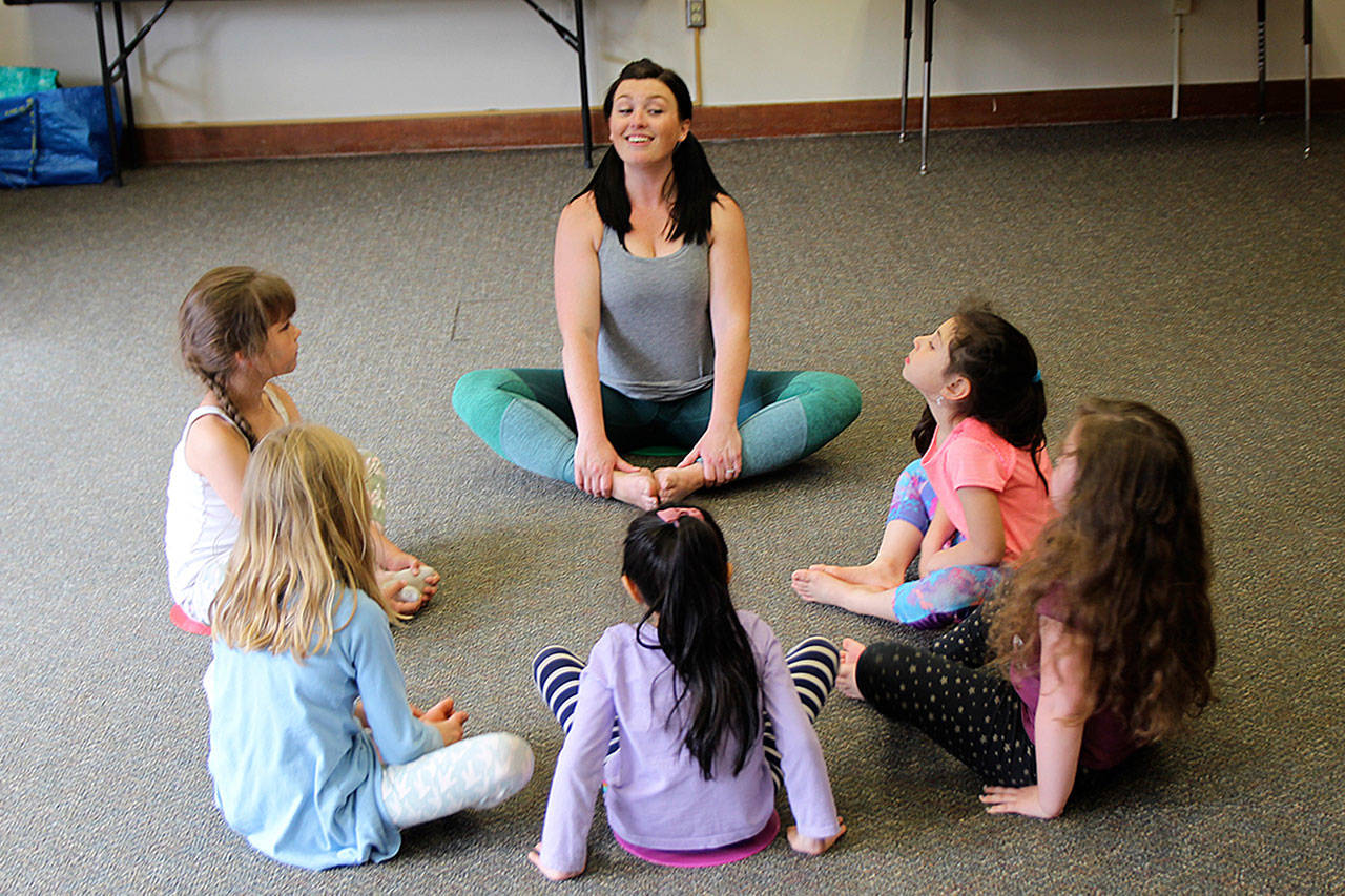 Alisha Walsh leads students in her Creative Dance class through meaningful movements, including dancing, spinning, stretching and yoga poses. Photo by Maria Matson/Whidbey News Group